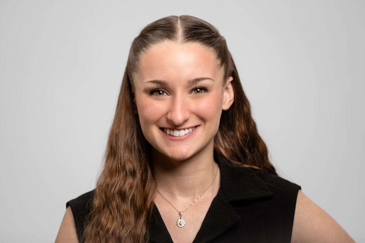 A woman smiles at the camera.