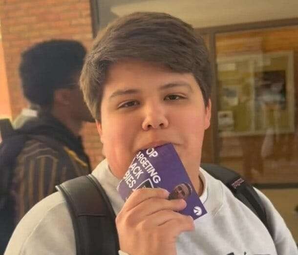 Pro-choice student eats pro-life marketing material at Students for Life table.
