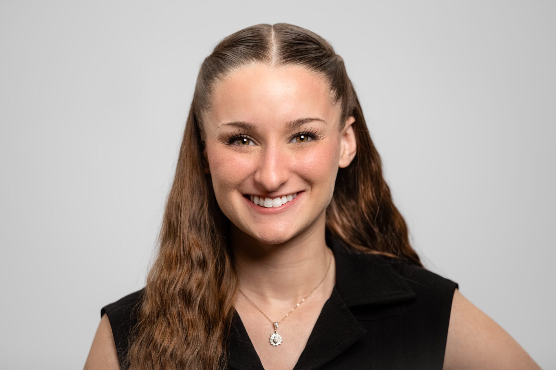 A woman smiles at the camera.