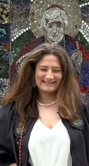 A woman smiles at the camera.