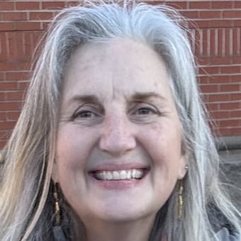 A woman smiles at the camera.