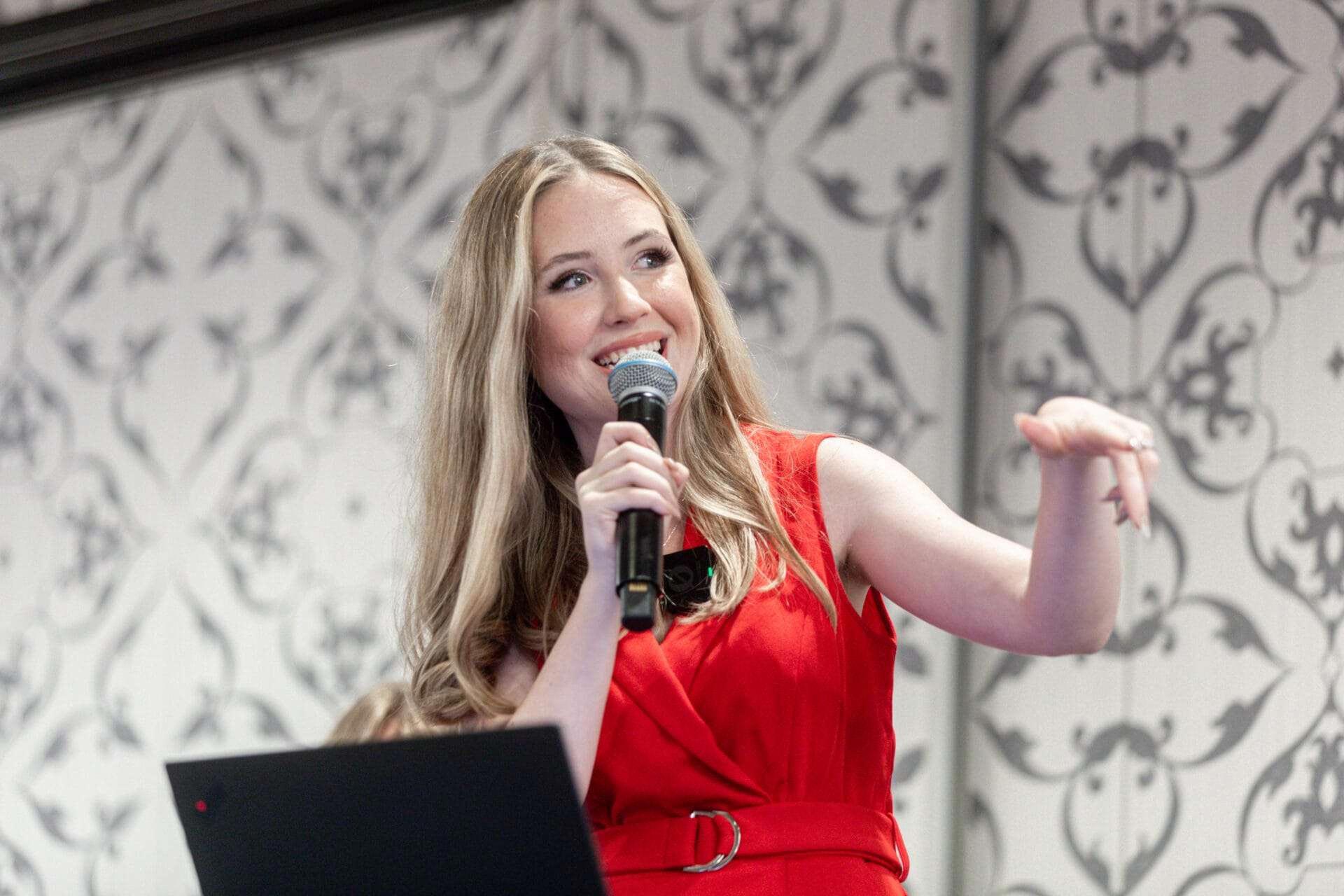 A woman speaks into a microphone.