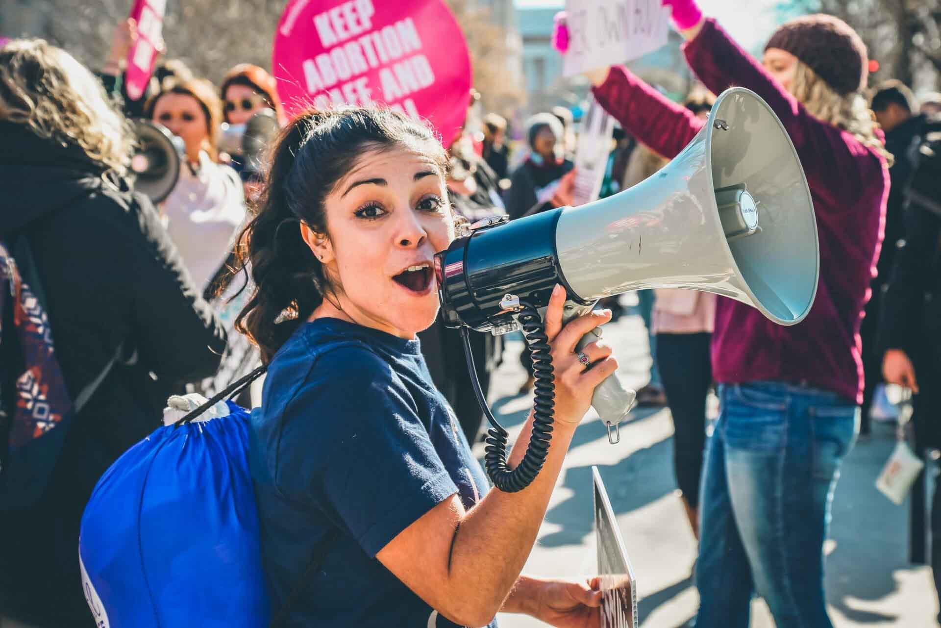 Female protester uses bullhorn at abortion rally