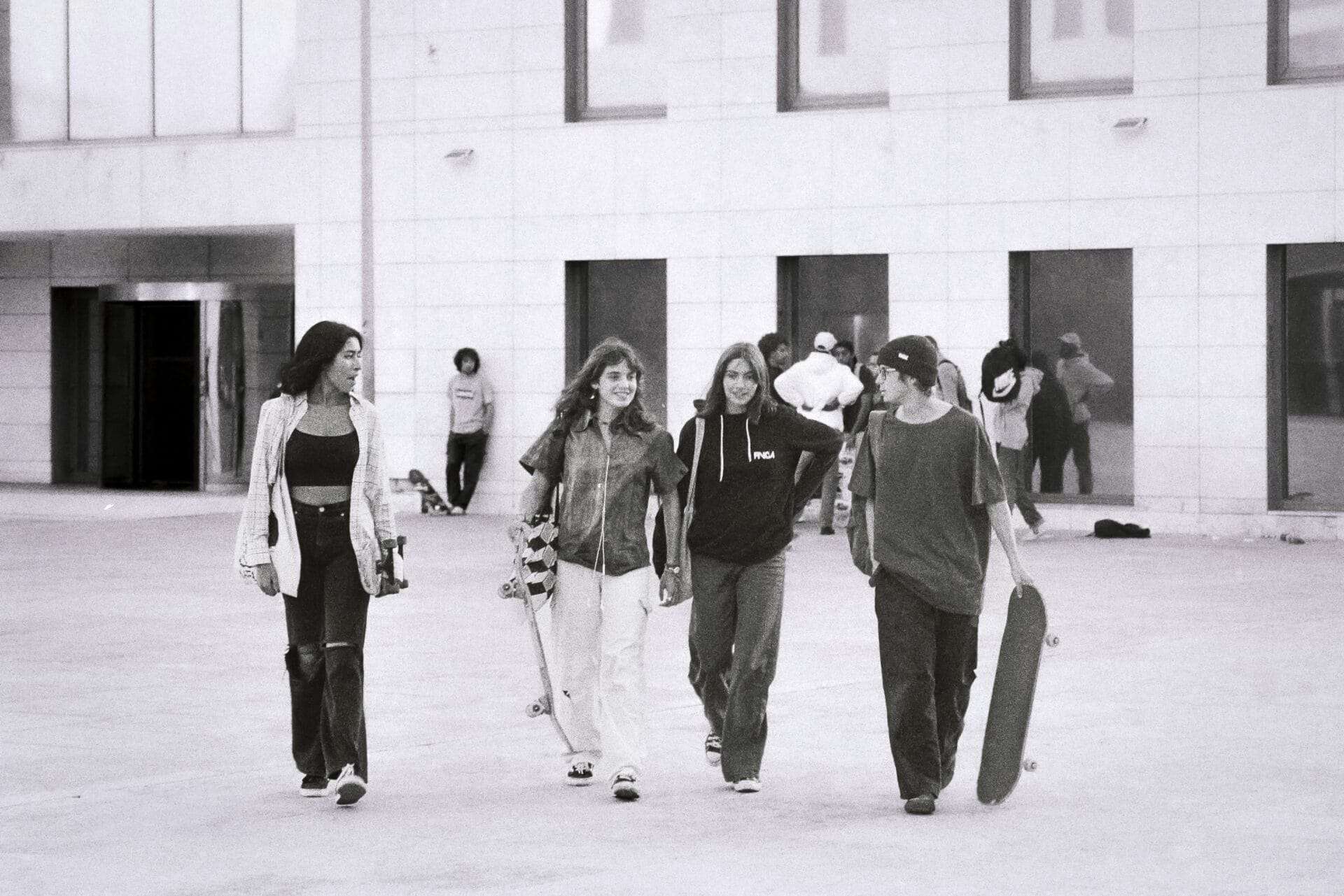 A group of people talk while walking together.